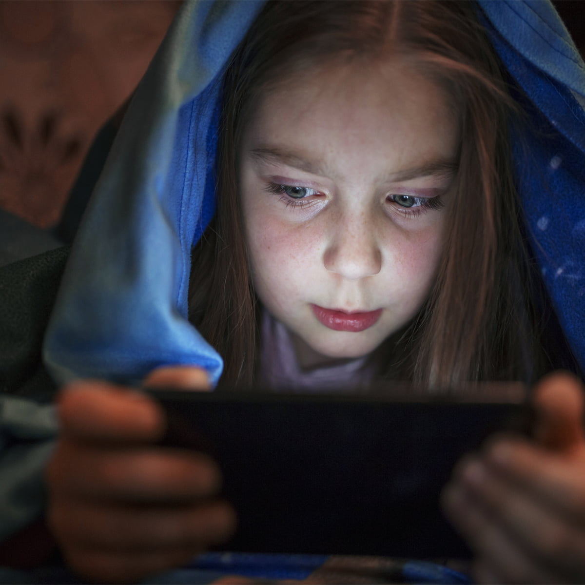 girl playing phone during night time